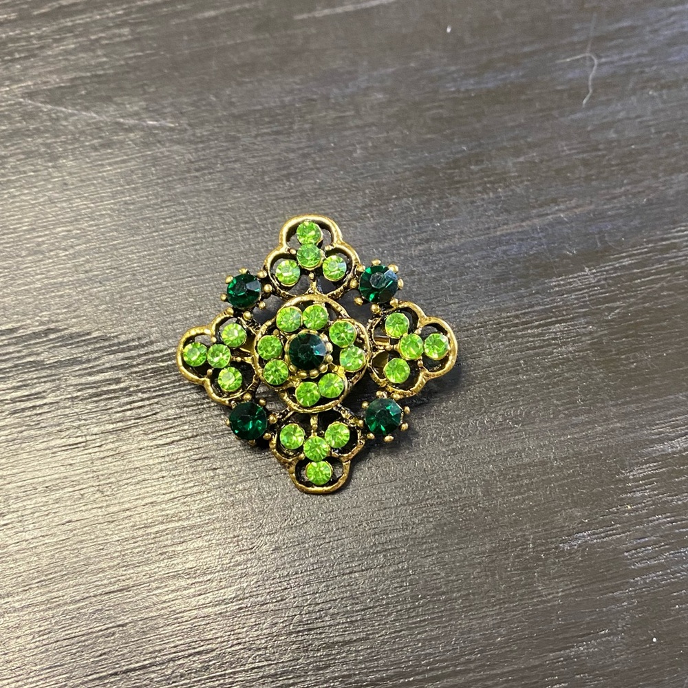 Retro gold brooch with green rhinestones